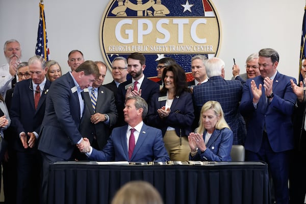 Governor Brian Kemp shakes with Rep. Jesse Petrea, R-Savannah, also known as Georgia Criminal Alien Track and Report Act from 2024 in the Georgia Public Training Center in Forsyth., GA.