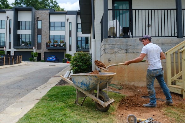 A construction worker works on Monday, July 25, 2022, in a town house complex in Decatur. The projected high is 90 degrees. (Arvin temkar / arvin.temkar@ajc.com)