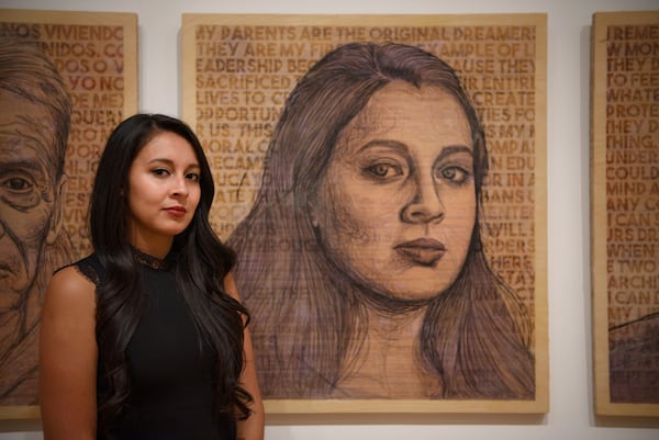Artist and activist Yehimi Cambrón in front of a self -portrait in the High Museum of Art. Photo with the kind permission of Kristin Ferro.