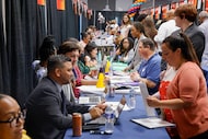 Candidates speak to various school officials during a job fair in Dallas ISD in South Oak ...