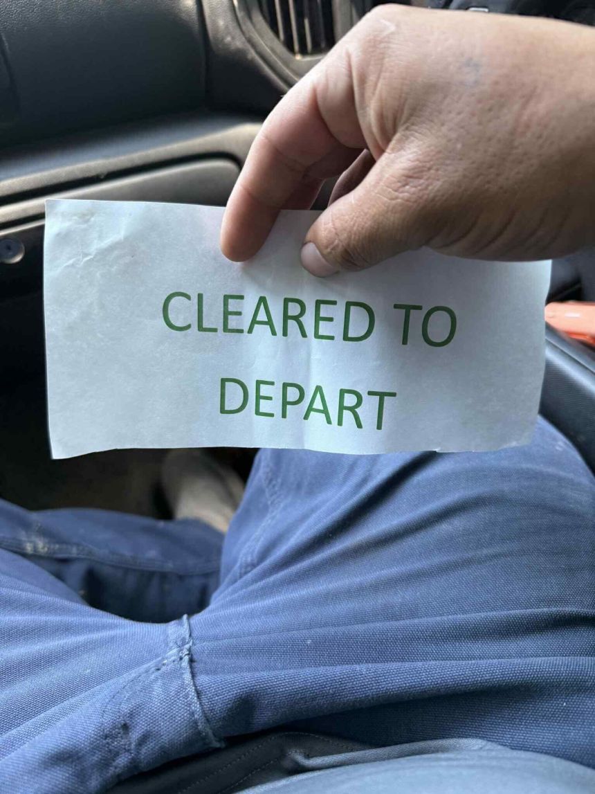 A worker determined to be in the country legally shows a pass given to him by authorities raiding the Hyundai-LG battery plant n Ellabell, Georgia, September 5, 2025.